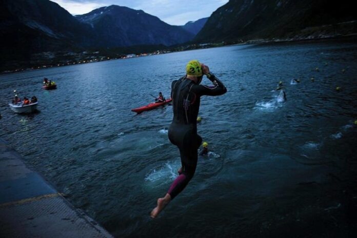 Huub triathlete jumps into the icy Hardangerfjord fjord at the Norseman Xtreme triathlon