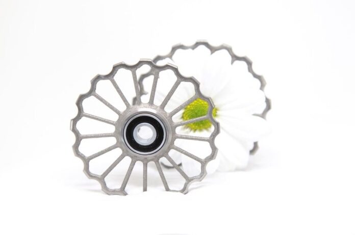 CeramicSpeed new 3D printed hollow Titanium Oversized Pulley Wheel inspired by nature and the Danish national flower, the marguerite daisy CeramicSpeed new 3D printed hollow Titanium Oversized Pulley Wheel inspired by nature and the Danish national flower, the marguerite daisy