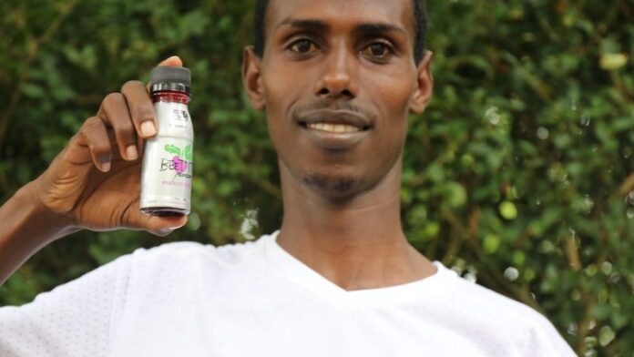 NN Running Team member Augustino Sulle with the high nitrate Beet It Sport shot NN Running Team member Augustino Sulle with the high nitrate Beet It Sport shot