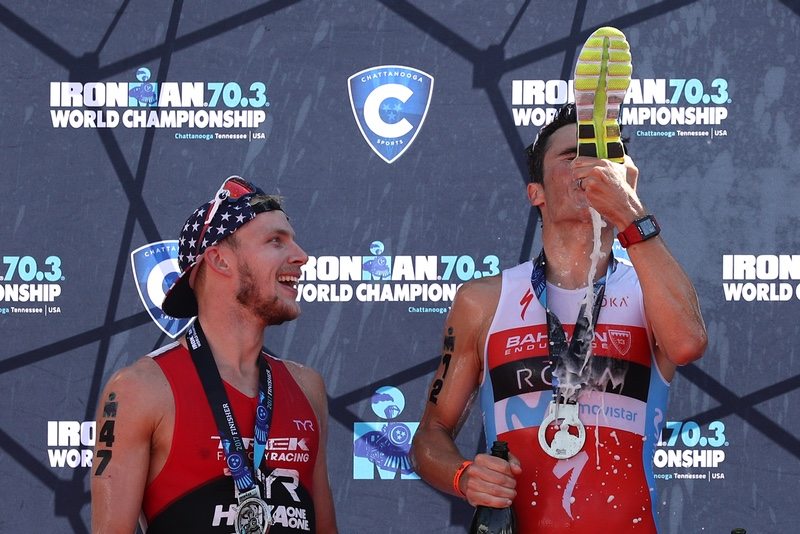 CHATTANOOGA, TN - SEPTEMBER 10: (L-R) Ben Kanute of the USA (second place) watches Javier Gomez of Spain (first place) as he drinks champagne from a running shoe as they celebrate on the podium after the IRONMAN 70.3 Men's World Championship on September 10, 2017 in Chattanooga, Tennessee. (Photo by Patrick Smith/Getty Images for IRONMAN)
