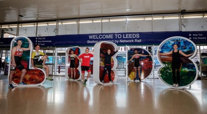 British Triathlete Jess Learmonth (centre) and local triathletes launch entries at Leeds station for the ITU World Triathlon Leeds 2018
