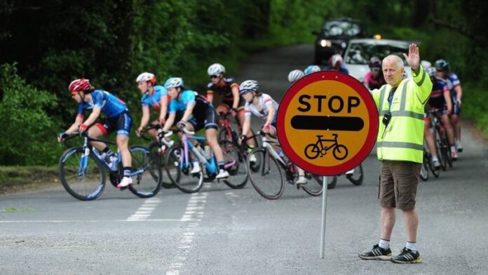 Stop Cycle Race sign - accredited marshalls - photo - British Cycling