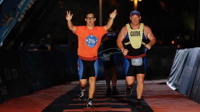210104_Chris Nikic and guide - Photo credit- Michael Reaves & Jonathan Bachman - Getty Images for IRONMAN