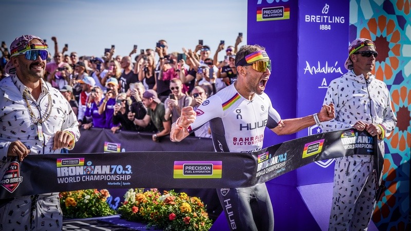 Precision Fuel & Hydration (PF&H) - Andy Blow and Jonny Tye holding tape for Jelle Geens at IRONMAN 70.3 World Championship in Marbella, Spain
